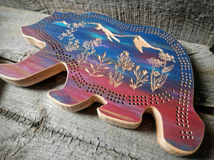 Handcrafted, CNC-carved bear-shaped hard maple cribbage board, artisan-made in Montana, Mountain wildflower scene Sunset color