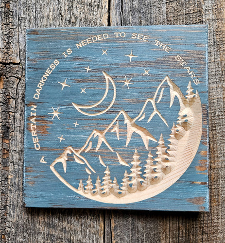 A certain darkness is needed to see the Stars wood carved sign with mountain night scene. Made in Montana Knotty Pine Woodworks 